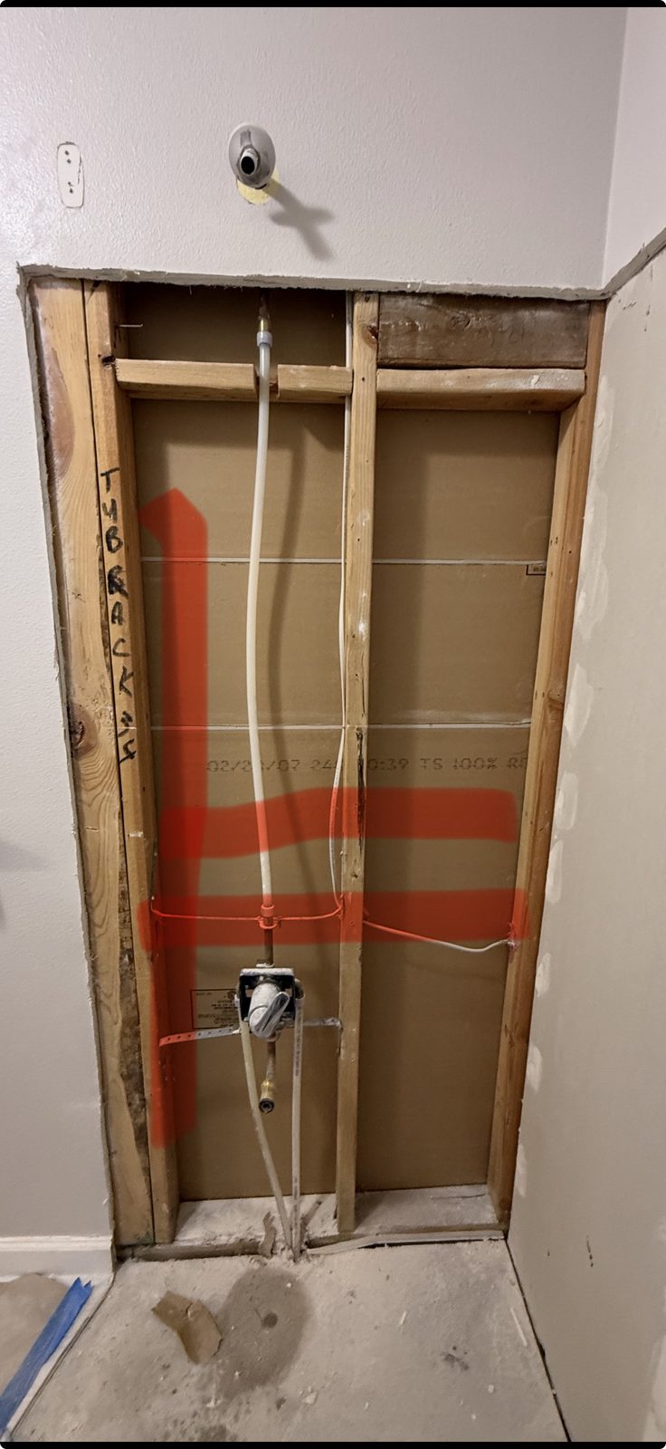 Open stud wall with red lines marking where additional framing will be added